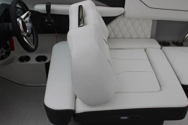 Slide: The Image of 2024 Regal LS6 Surf boat interior with white leather seating and modern steering wheel. - 42