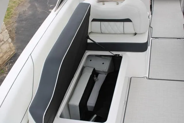 Slide: The Image of 2024 Regal LS6 Surf boat interior with open storage compartment. - 46