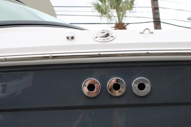 Slide: The Image of 2024 Regal LS6 Surf boat with chrome exhaust ports and sleek design. - 5