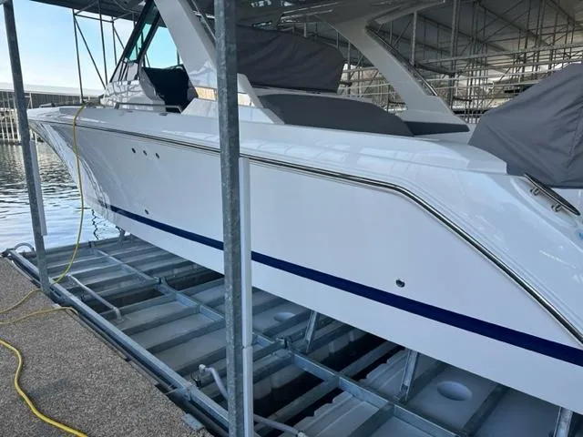 Slide: The Image of 2021 Tiara Yachts 34 LS docked in a marina. - 2