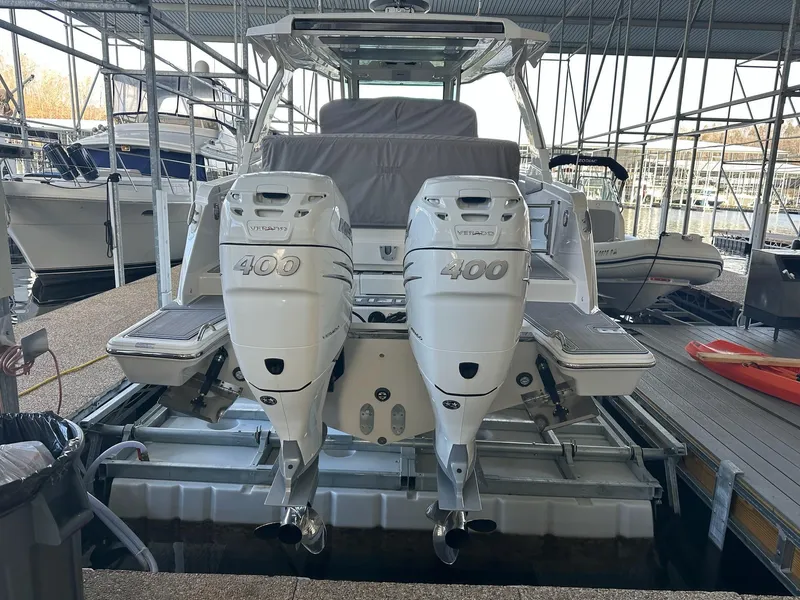 Slide: The Image of 2021 Tiara Yachts 34 LS with twin 400 horsepower engines docked in a marina. - 9