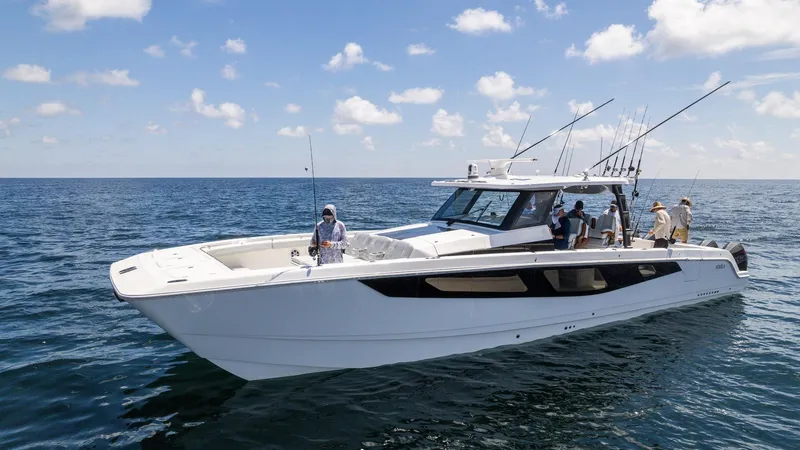 The Image of 2024 Aquila 47 Molokai boat on open water with people fishing. - 0