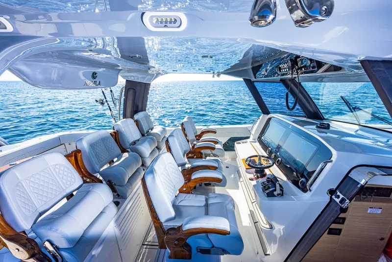 Slide: The Image of 2024 Aquila 47 Molokai yacht cockpit with luxurious seating and advanced navigation systems. - 12