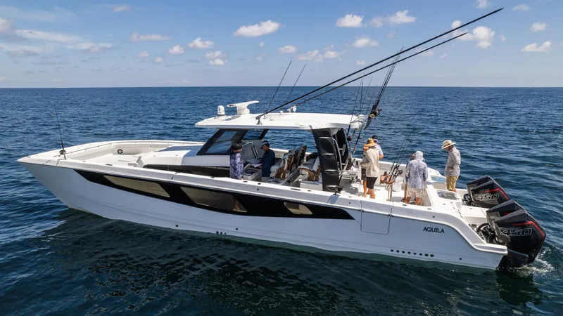 Slide: The Image of 2024 Aquila 47 Molokai yacht on open water with people onboard. - 2