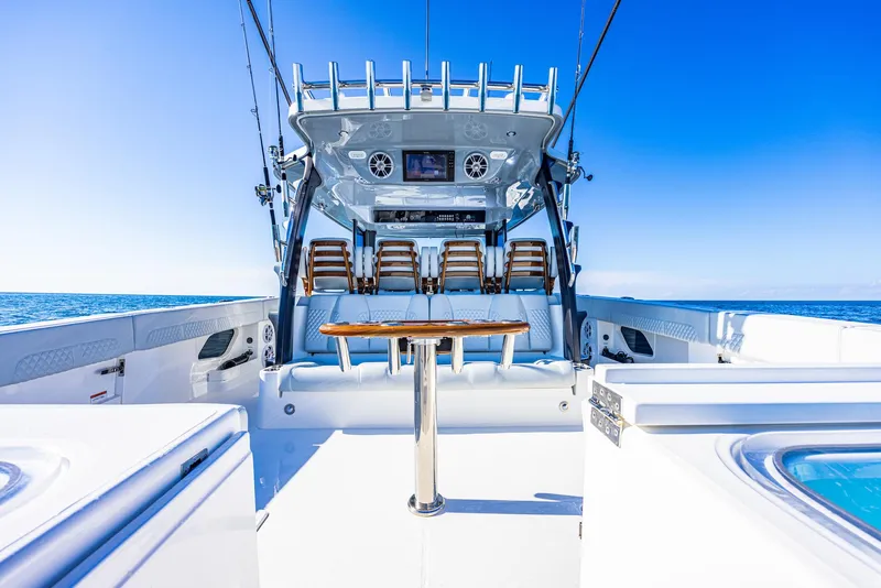 Slide: The Image of 2024 Aquila 47 Molokai boat interior with seating and table on open water. - 22