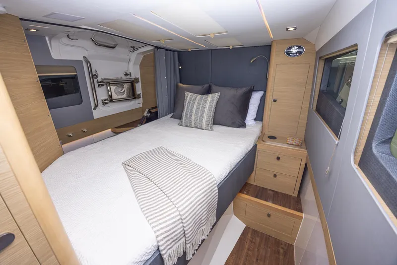 Slide: The Image of 2024 Aquila 47 Molokai yacht bedroom with modern design and cozy bedding. - 24