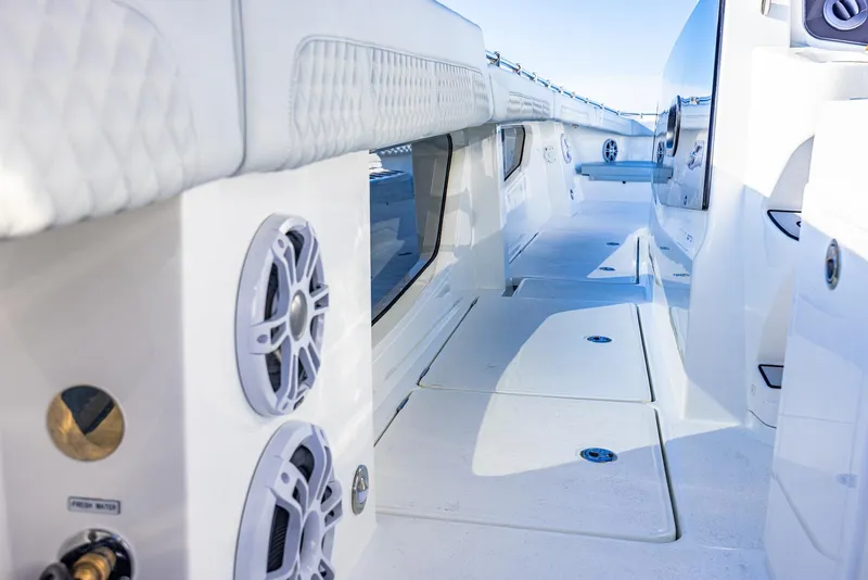 Slide: The Image of 2024 Aquila 47 Molokai yacht deck with speakers and white seating. - 27
