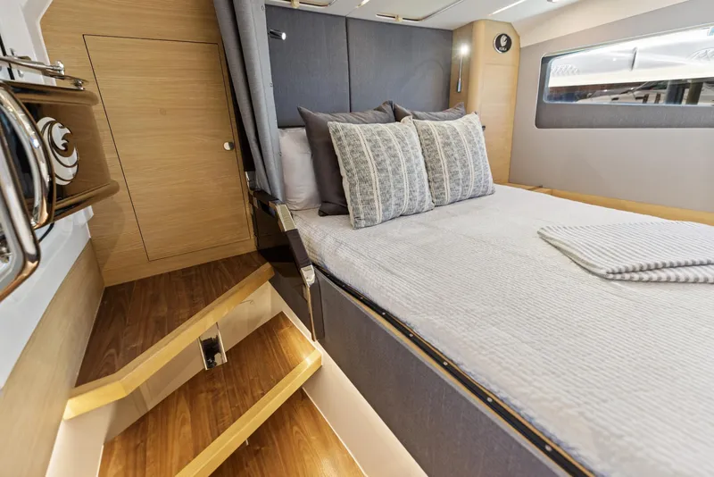 Slide: The Image of 2024 Aquila 47 Molokai cabin interior with bed, wooden flooring, and modern decor. - 28