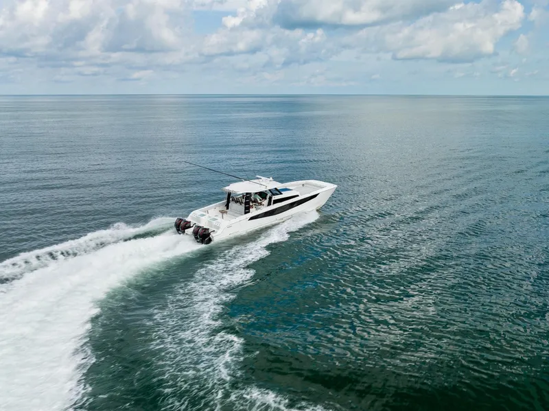 Slide: The Image of 2024 Aquila 47 Molokai cruising on open water under a partly cloudy sky. - 33