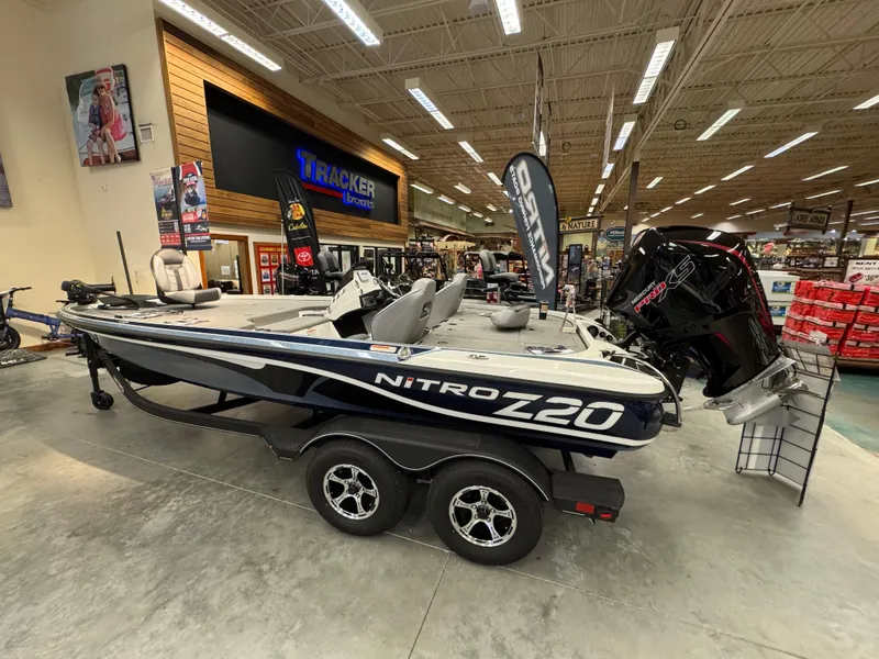 Slide: The Image of 2024 Nitro Z20 boat displayed in showroom with dual-axle trailer. - 1