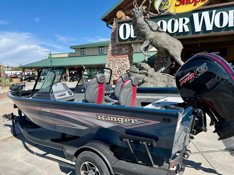 Slide: The Image of 2024 Ranger VS1782SC Angler boat displayed outside Outdoor World store. - 1