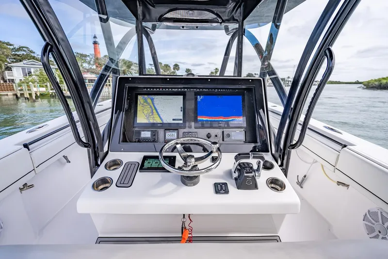 Slide: The Image of 2020 SeaHunter 35 Tournament boat dashboard with navigation screens and steering wheel. - 24