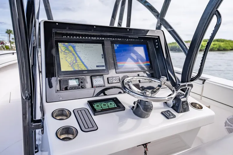 Slide: The Image of SeaHunter 35 Tournament 2020 boat dashboard with navigation screens and controls. - 25