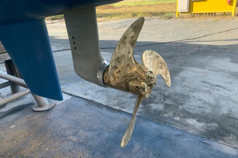 Slide: The Image of Boat propeller of a 2002 Dolphin 43, displayed on a stand outdoors. - 21