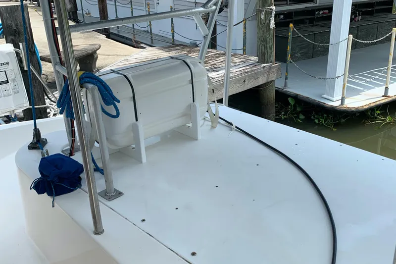Slide: The Image of Boat deck of 2002 Dolphin 43, featuring dockside view and marine equipment. - 29