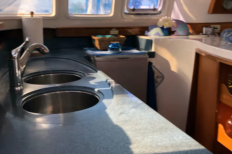 Slide: The Image of 2002 Dolphin 43 yacht kitchen with dual sinks and modern countertop. - 31