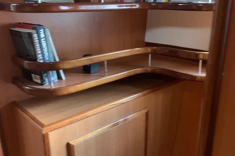 Slide: The Image of Wooden interior shelving with books in a 2002 Dolphin 43 model. - 35