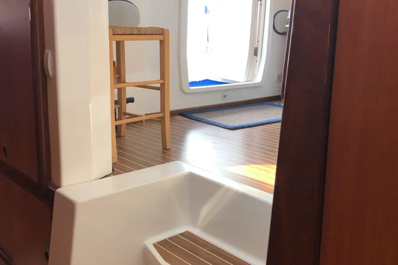 Slide: The Image of Interior of 2002 Dolphin 43 yacht with wooden flooring and seating area. - 38