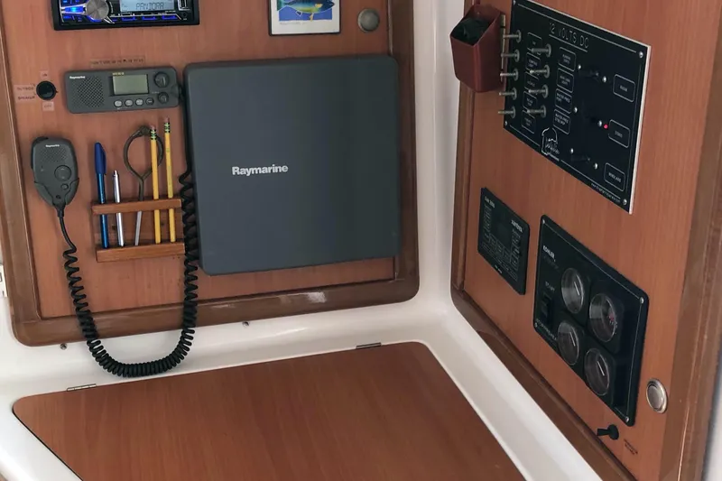 Slide: The Image of Control panel of a 2002 Dolphin 43 yacht with navigation and communication equipment. - 42