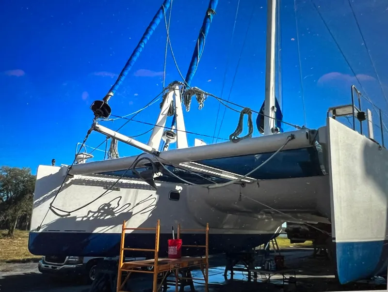 Slide: The Image of Sailboat on land, Dolphin 43 model, 2002, under maintenance with clear blue sky. - 7