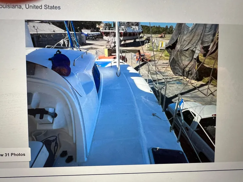 Slide: The Image of A 2002 Dolphin 43 sailboat on land in a Louisiana shipyard. - 8