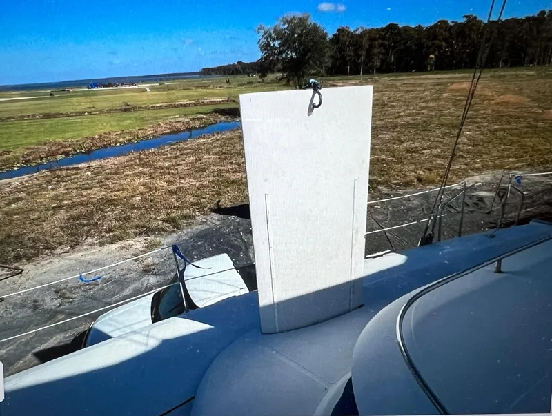 Slide: The Image of Sailboat deck with a raised panel, Dolphin 43 model, 2002, near a grassy landscape. - 9