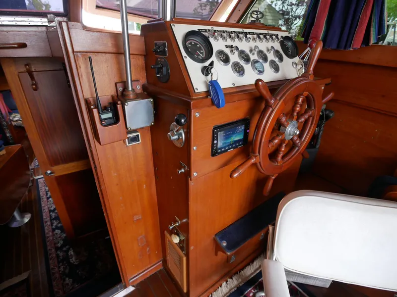 Slide: The Image of 1964 Egg Harbor 37 Convertible Sedan helm with wooden steering wheel and control panel. - 11
