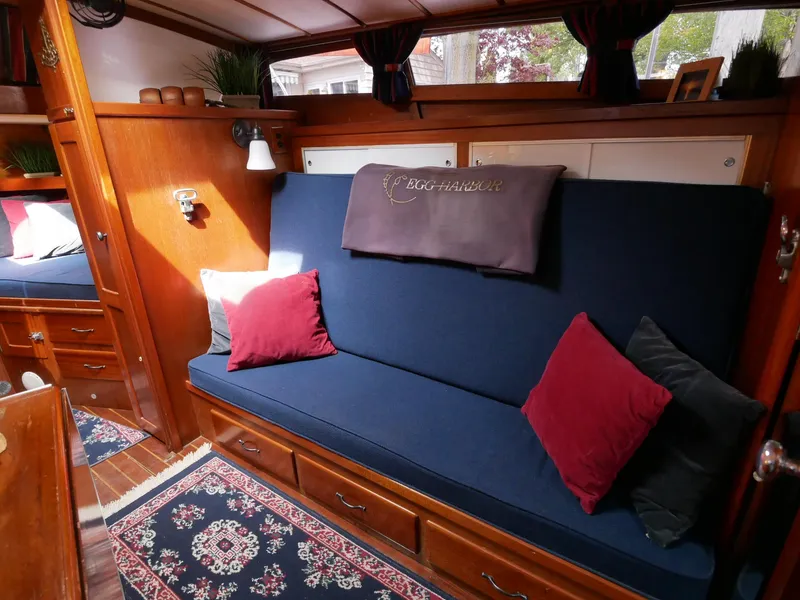 Slide: The Image of Interior of 1964 Egg Harbor 37 Convertible Sedan with blue sofa and red pillows. - 34