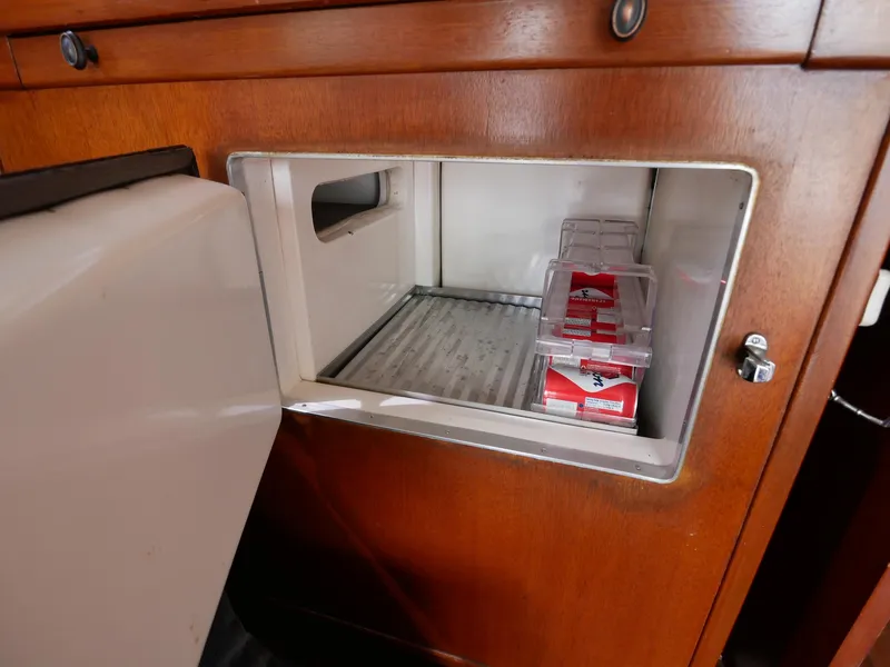 Slide: The Image of Built-in refrigerator in 1964 Egg Harbor 37 Convertible Sedan boat galley. - 12
