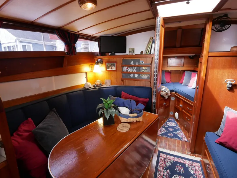 Slide: The Image of Interior of a 1964 Egg Harbor 37 Convertible Sedan with cozy seating and wooden finishes. - 15