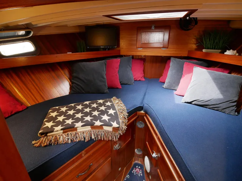 Slide: The Image of Cozy cabin interior of 1964 Egg Harbor 37 Convertible Sedan with blue and red cushions. - 17