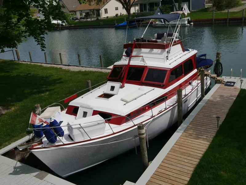 Slide: The Image of 1964 Egg Harbor 37 Convertible Sedan docked by a canal. - 2
