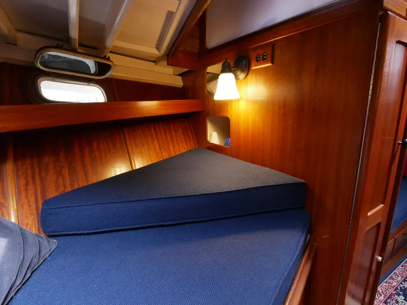 Slide: The Image of 1964 Egg Harbor 37 Convertible Sedan cabin with wooden interior and blue cushions. - 21