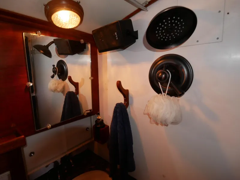 Slide: The Image of Bathroom interior of 1964 Egg Harbor 37 Convertible Sedan boat with mirror and showerhead. - 25