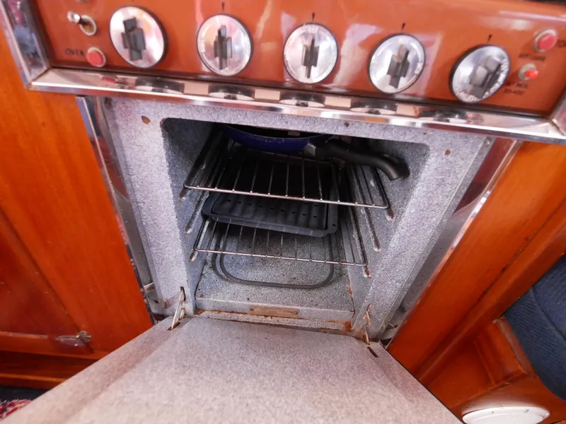 Slide: The Image of 1964 Egg Harbor 37 Convertible Sedan oven with open door and control knobs. - 29