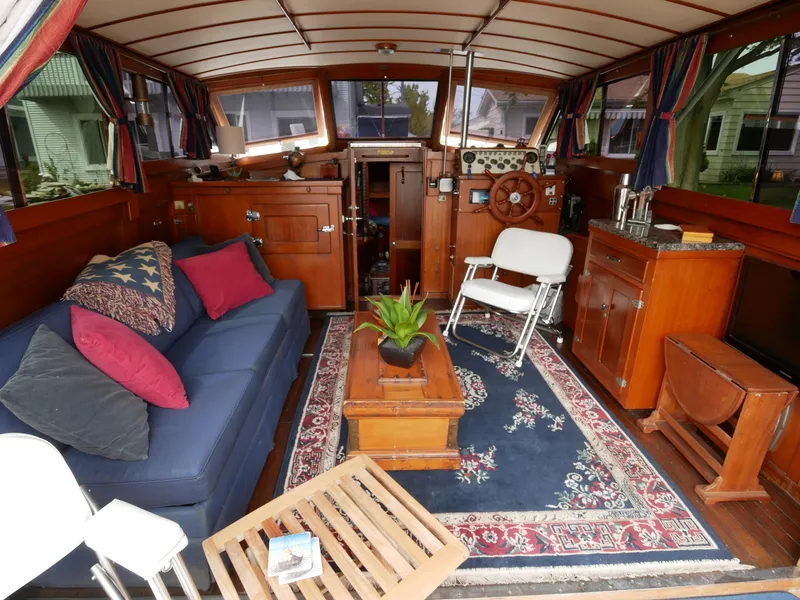 Slide: The Image of Interior of a 1964 Egg Harbor 37 Convertible Sedan with cozy seating and nautical decor. - 3