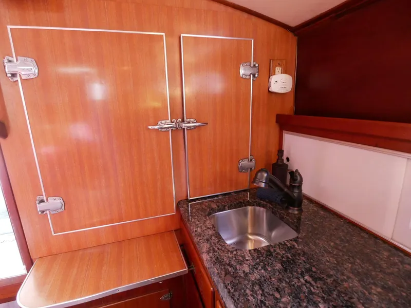 Slide: The Image of 1964 Egg Harbor 37 Convertible Sedan kitchen with granite countertop and stainless steel sink. - 33