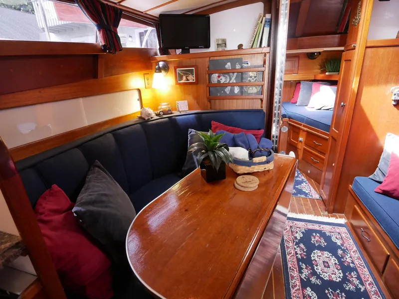 Slide: The Image of 1964 Egg Harbor 37 Convertible Sedan interior with cozy seating and wooden table. - 35