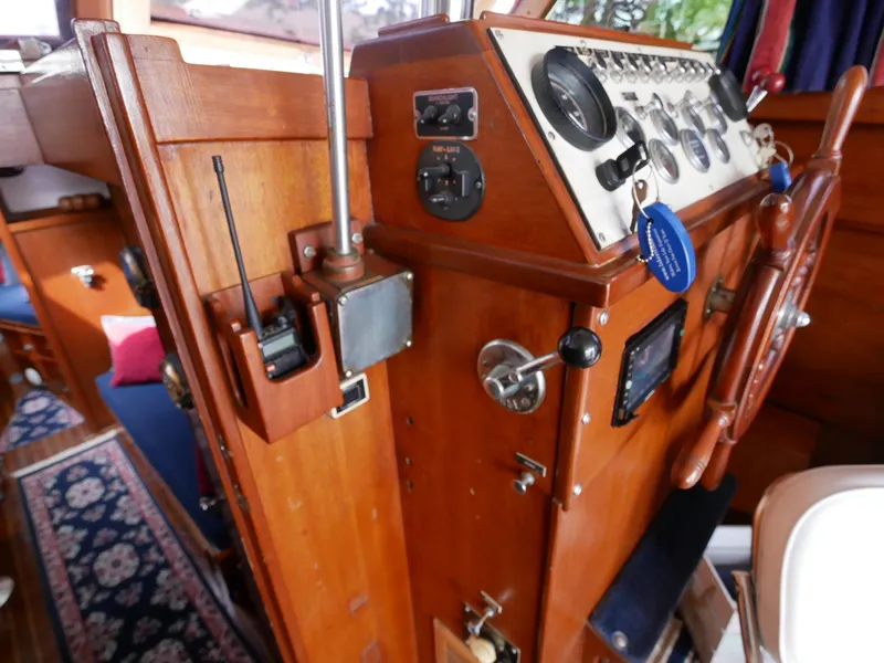 Slide: The Image of 1964 Egg Harbor 37 Convertible Sedan boat helm with wooden dashboard and control panel. - 36