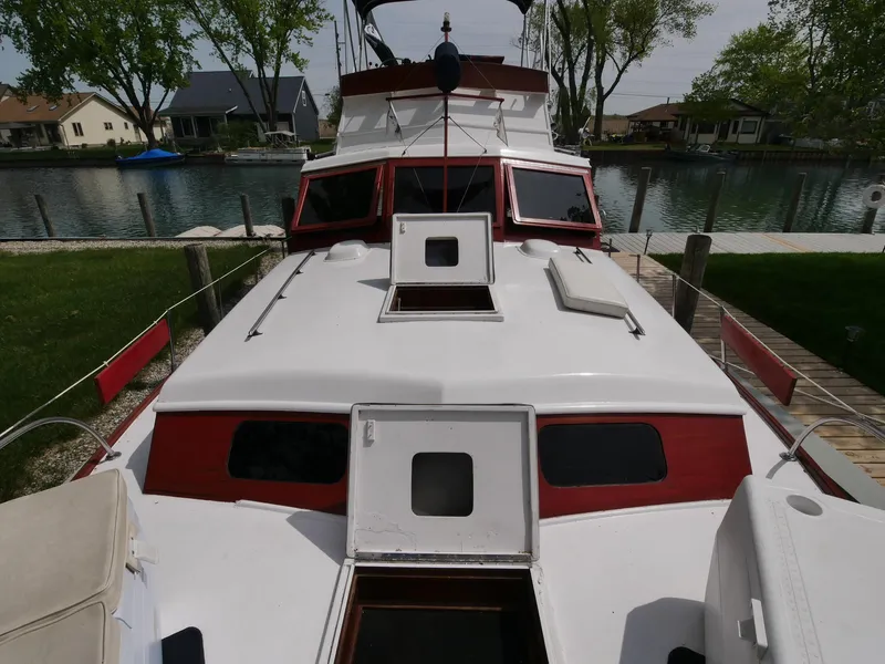 Slide: The Image of 1964 Egg Harbor 37 Convertible Sedan docked by a canal. - 4