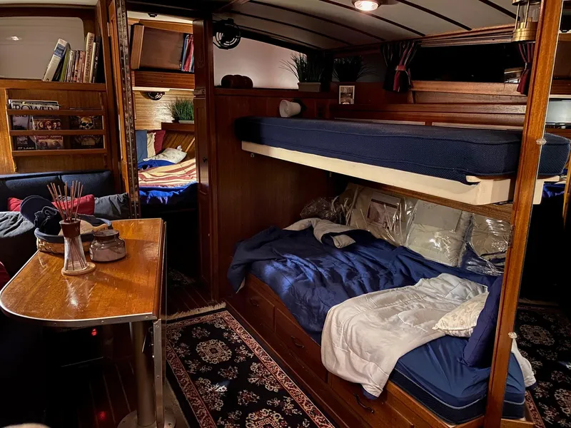 Slide: The Image of Interior of a 1964 Egg Harbor 37 Convertible Sedan with cozy bunk beds and wooden furnishings. - 50