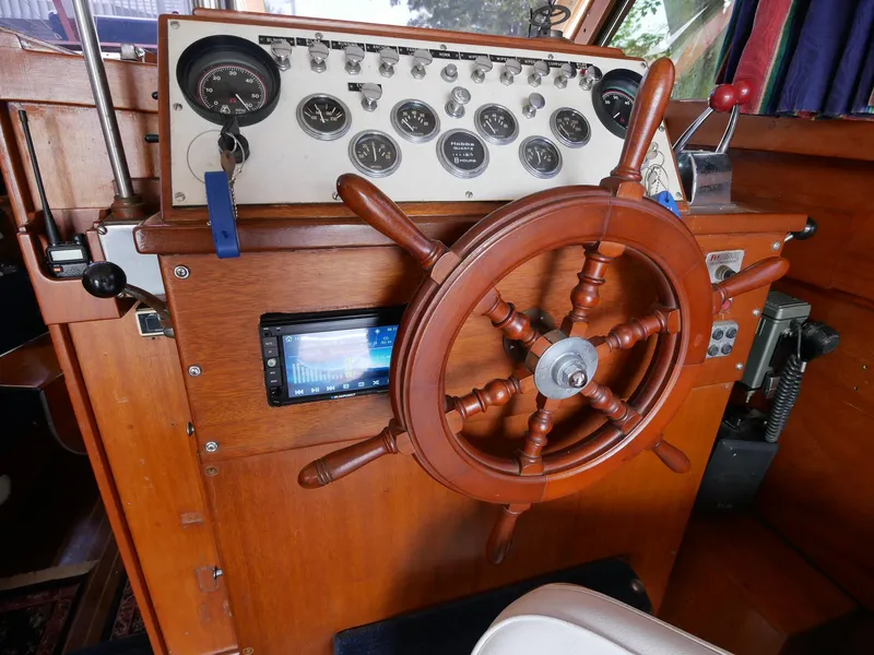 Slide: The Image of 1964 Egg Harbor 37 Convertible Sedan boat helm with wooden steering wheel and instrument panel. - 7