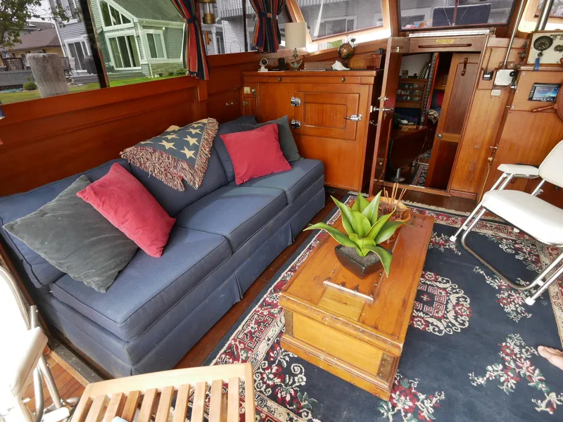 Slide: The Image of Interior of 1964 Egg Harbor 37 Convertible Sedan with blue sofa and wooden furnishings. - 8