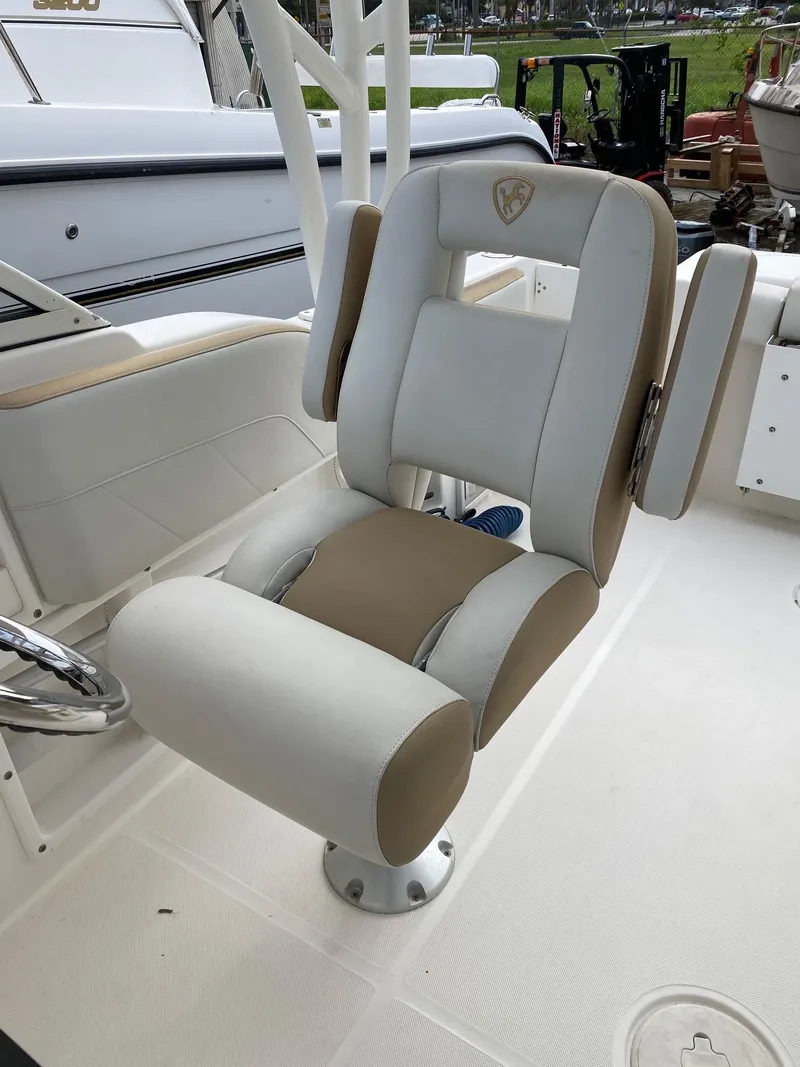 Slide: The Image of Captain's chair on a 2017 Century 24 Resorter boat, featuring beige and white upholstery. - 14