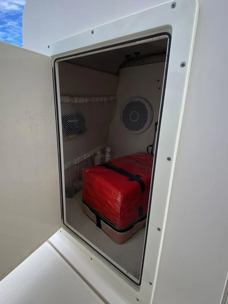 Slide: The Image of Storage compartment on a 2017 Century 24 Resorter boat with red equipment box. - 20