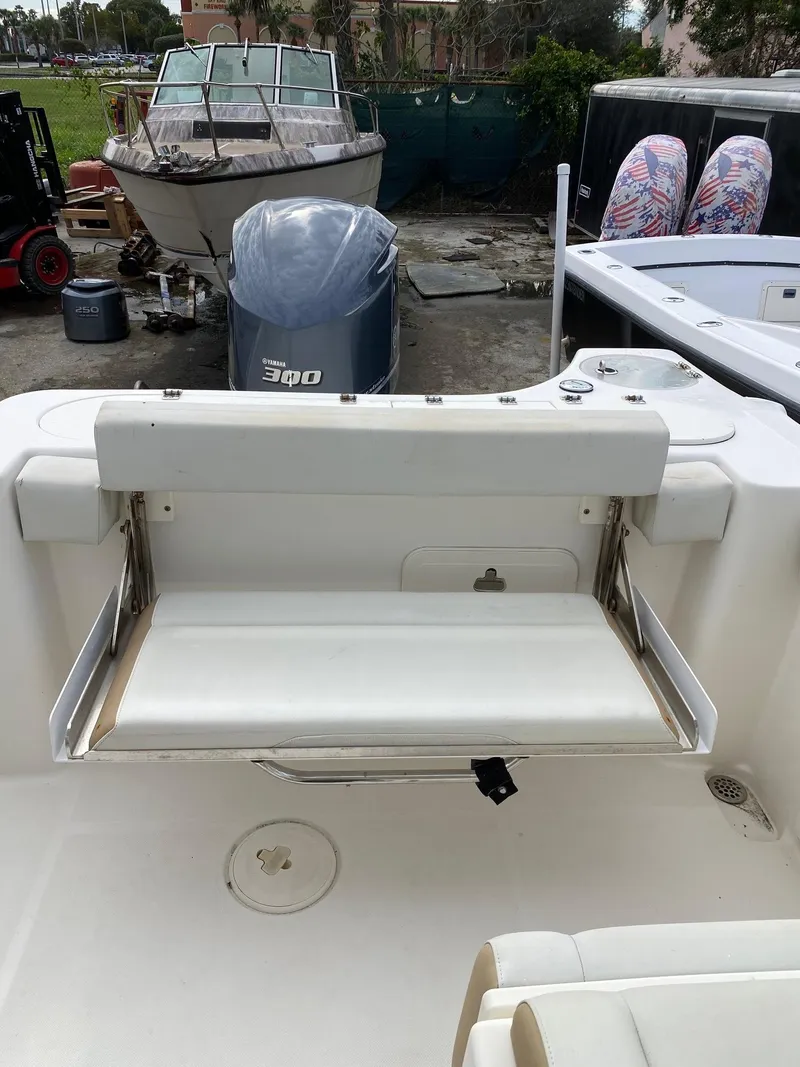 Slide: The Image of 2017 Century 24 Resorter boat with fold-down transom seat and outboard motor. - 25