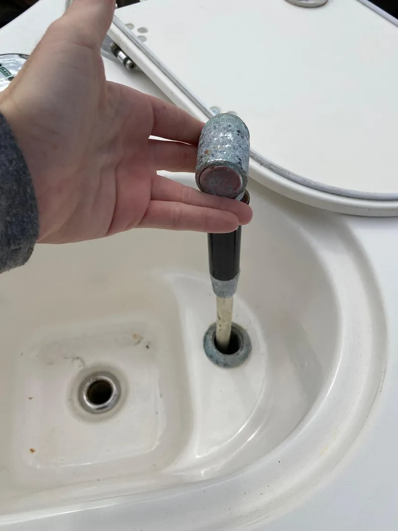 Slide: The Image of Hand holding a faucet in a Century 24 Resorter boat, 2017 model. - 27