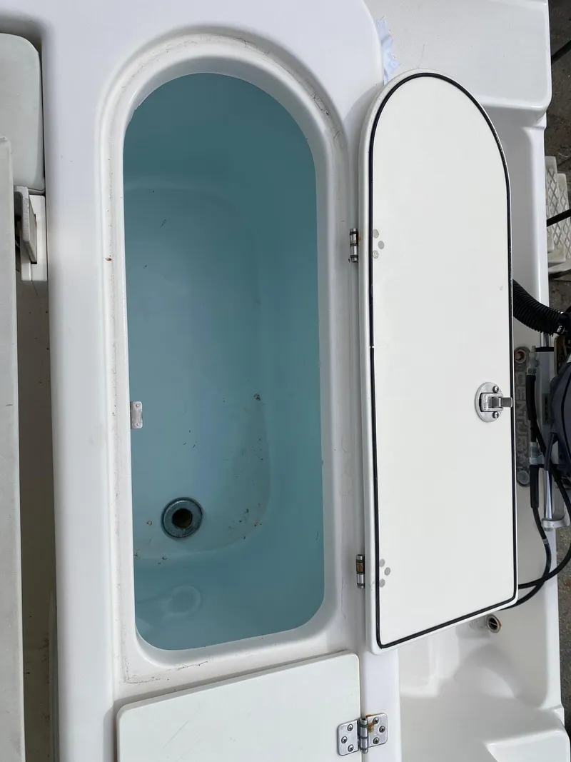 Slide: The Image of Open storage compartment on a 2017 Century 24 Resorter boat. - 28