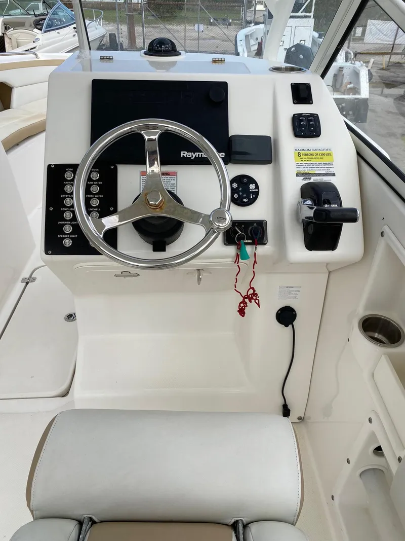 Slide: The Image of Century 24 Resorter 2017 boat helm with steering wheel and control panel. - 7