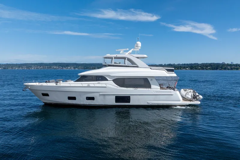 Slide: The Image of 2017 Ocean Alexander 70 E yacht cruising on a calm blue sea under a clear sky. - 1